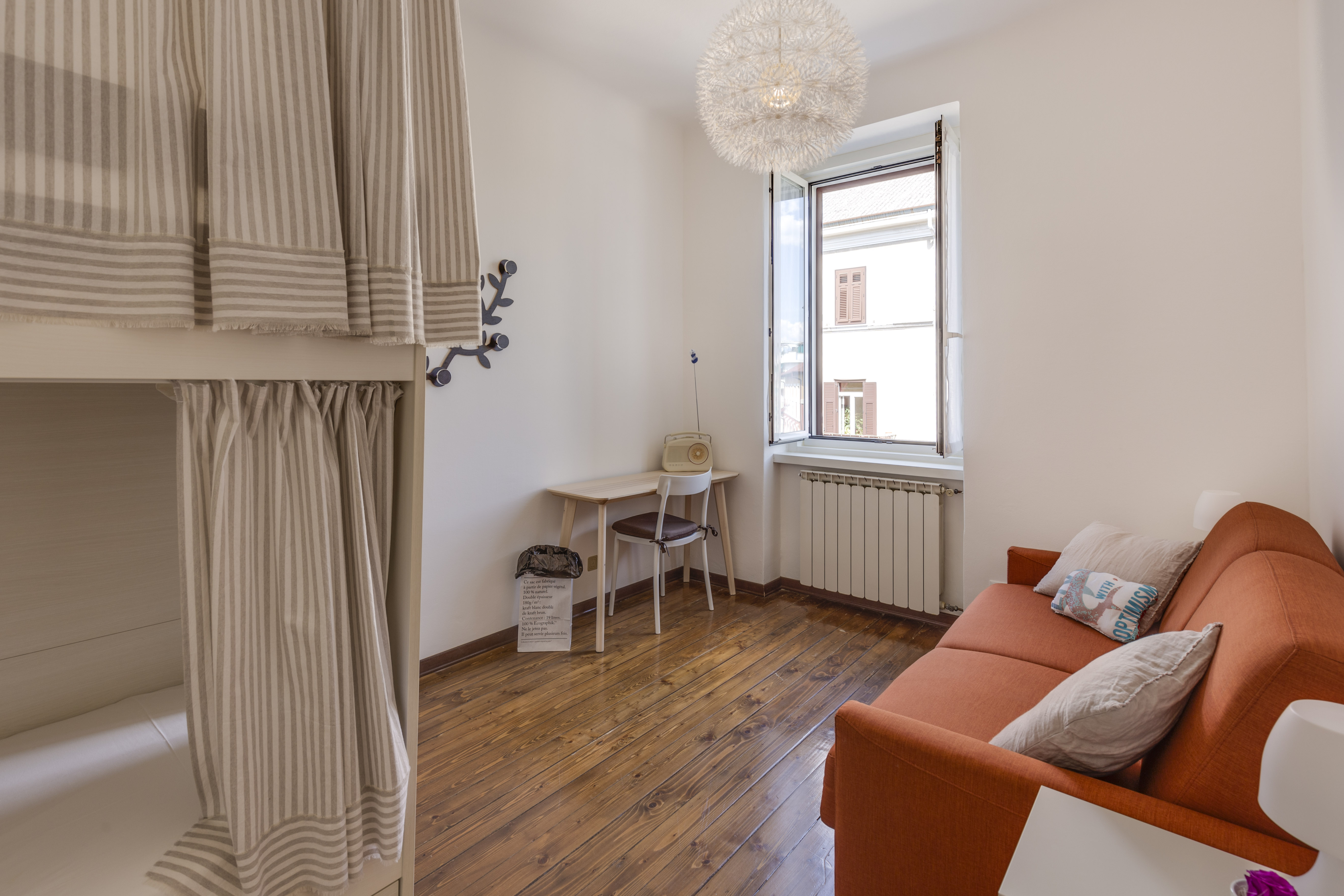 Orange-sofa-and-bunk-bed-with-curtains-NewInteriorSolutions.com